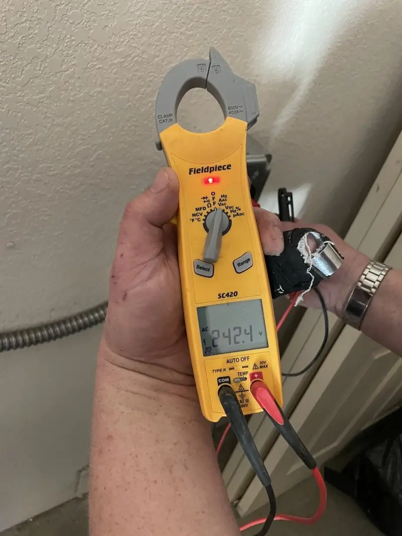 Voltage testing with clamp meter during Ceiling Fan Installation in Pelican Bay